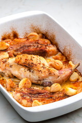 baked rabbit leg with garlic and bacon