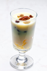 vanilla custard with nuts and raisins in a glass