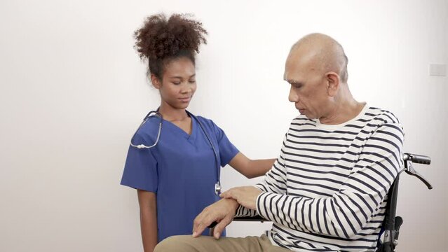 Doctor nurse black woman in blue uniform talks, encourages and checks a cancer patient. World Cancer Day. - Powered by Adobe