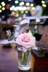 Aesthetic simple pastel rose vase with eucalyptus leaves at event table