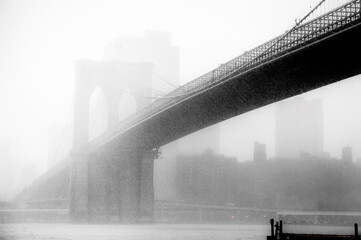 Brooklyn Bridge in fog and rain, looking from Brooklyn towards NYC from under the Bridge.