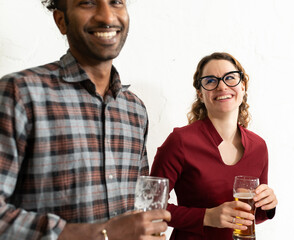 People drinking beer at paub, white wall background