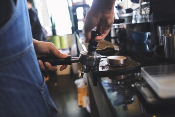 person working on a coffee machine