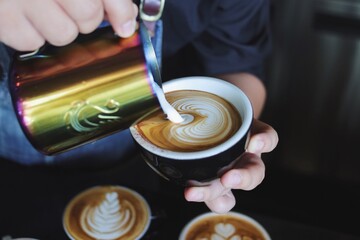 pouring milk into coffee cup