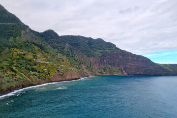 The green slopes of the island of Madeira. A popular tourist Portuguese island in the ocean.