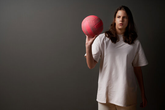 Serious teen girl with baseketball ball
