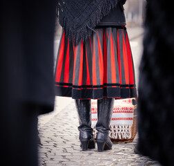 people with easter baskets in traditional sekler hungarian red black dress