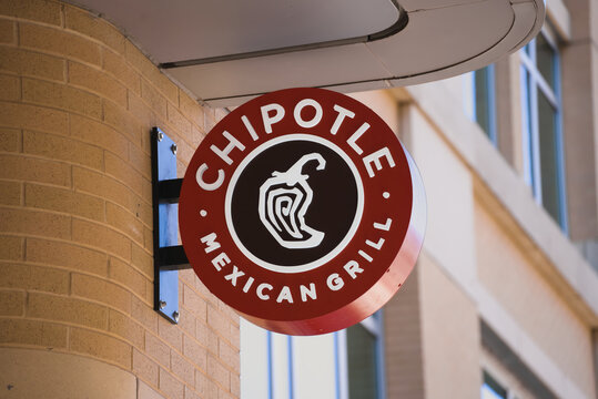 Arlington, VA - April 2, 2023 : Chipotle Mexican Grill circular round sign on popular street in Virginia.