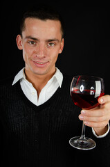 Young attractive man is drinking red wine.