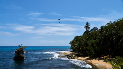 Fototapeta na wymiar kitesurfer above a beach in caribbean costa rica