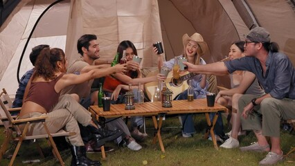 Happy young friends traveler group having fun music together in camping party, Group of multiculturalism hipster people enjoying holiday vacation trip in campsite