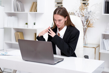 Woman in the office looking at the laptop screen