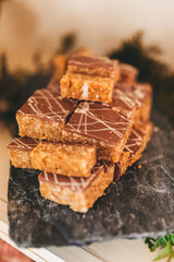 Chocolate pastries on a stone tray.