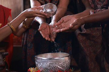 Pour water on the hands of revered elders and gives blessing , Thai woman with traditional dress respect to elder ,Songkran festival