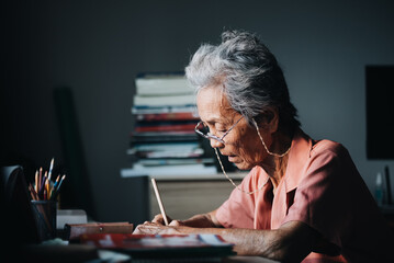 Asian elderly woman Reading books for learning, developing the brain, preventing dementia