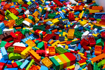 View on multi color plastic bricks at the table.