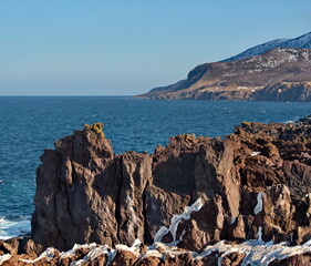 Russia. Far East, Kuril Islands. Very hard and sharp basalt rocks along the coast of the Sea of...