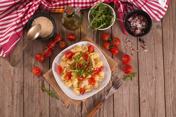 Orecchiette pasta with arugula and tomato.