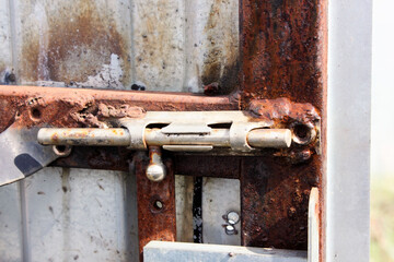 latch on the door. the old metal rusty door is locked. Abandoned Locked Gate