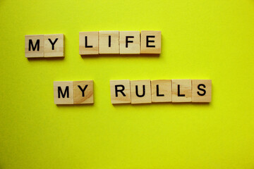my life my rules. lettering on the grass of paper-cut words.