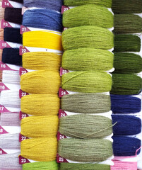 Various colorful threads for embroidery as background. Hobbies, needlework. Background. View from above.