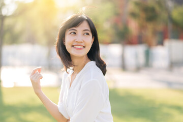 Portrait young beautiful asian woman with happy smile around outdoor park in sunny summer day