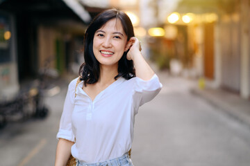 Portrait beautiful asian woman traveler smiling while explore street on summer vacation in Bangkok, Thailand