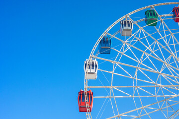 Ferris wheel against the clear blue sky