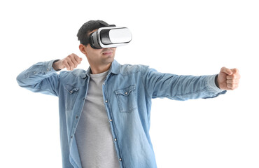 Young man using VR glasses on white background