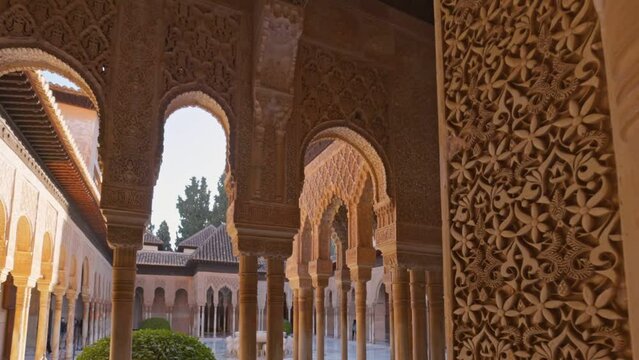 Decorated room and yard in Alhambra, Granada. Camera moves between walls and columns with moorish architecture of Court of the Lions, Alhambra, Granada, Andalucia , Spain, Europe. Gimbal shot, 4K