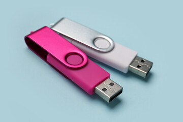 USB flash drives on color background