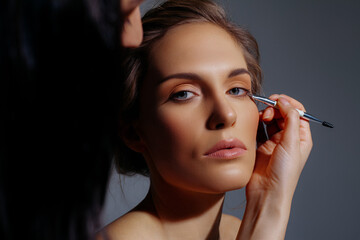 Obraz premium Makeup of white girl on gray background