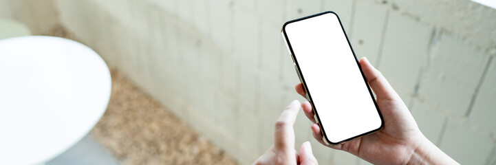 Hand holding empty white screen smart phone on white background.