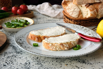 Cooked bruschetta from homemade bread with cream cheeses on beautiful white plates.