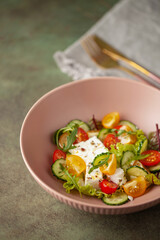 Easy greek salad of fresh cucumber, tomato, arugula,  feta cheese  with olive oil. Healthy food.