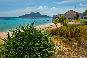 Malaysia. East coast of Borneo. An overgrown sandy beach on the reef island of Mabul, famous all over the world for its diving clubs.