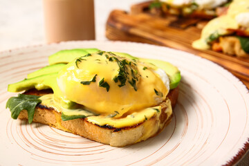 Plate with delicious egg Benedict on table, closeup
