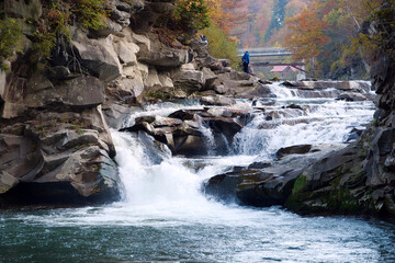 People near Prut river and Probiy waterfall, Carpathian Mountains, Ukraine