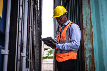 African American Foreman control or check inventory details of containers box, worker checking quantity of product in containers.