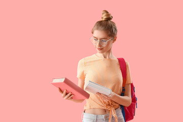 Female student with books and backpack on pink background