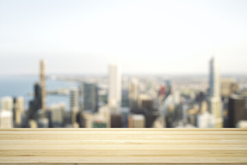 Empty tabletop made of wooden dies with blurry city view in sunny weather on background, template