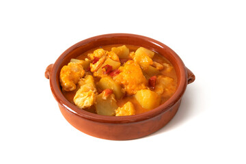 Potato stew with cod, served in a clay bowl. Isolated on white background. Spanish food concept.