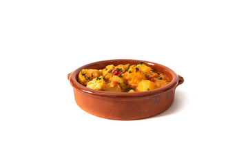 Potato stew with cod, served in a clay bowl. Isolated on white background. Spanish food concept.