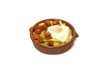 Chistorra with fried potatoes and fried eggs, served in a clay bowl (Chistorra, is a type of sausage of Navarre origin made with fresh minced pork.Isolated in a white background. Spanish food concept.