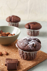 Tasty chocolate cupcakes on table