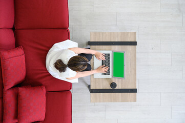 Top view of manager woman working at mock up green screen chroma key laptop with isolated display....