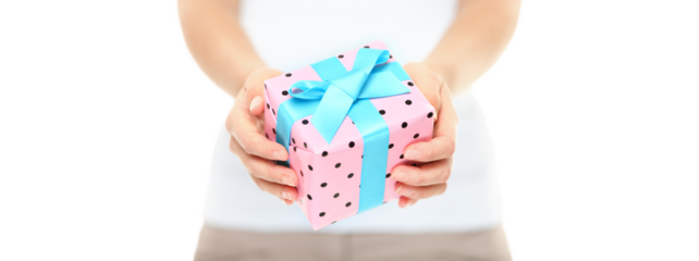 Hands holding a decorative gift box with pretty pink polka dot paper tied with a turquoise ribbon and bow for your Christmas greeting isolated cutout PNG on transparent background
