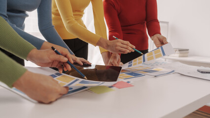 Group of ui ux developer brainstorming website wireframe mobile interface design on desk table.
