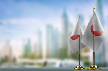 Small flags of the Japan on an abstract blurry background