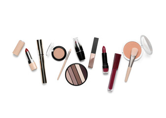Decorative cosmetics with brushes on white background, top view